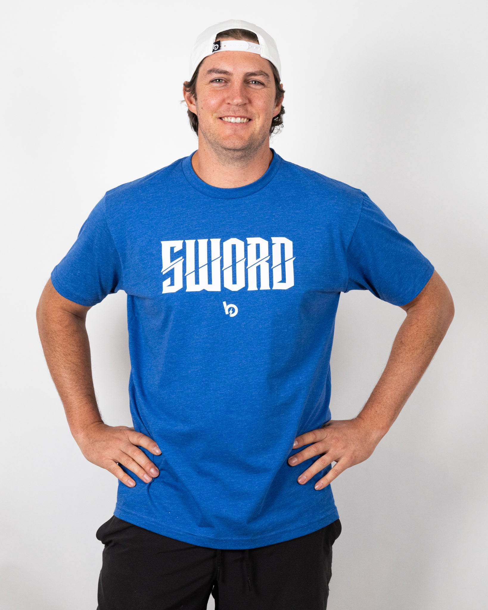 Model wearing the Bauer Outage Sword Logo Tee in blue with the 'SWORD' logo prominently displayed.