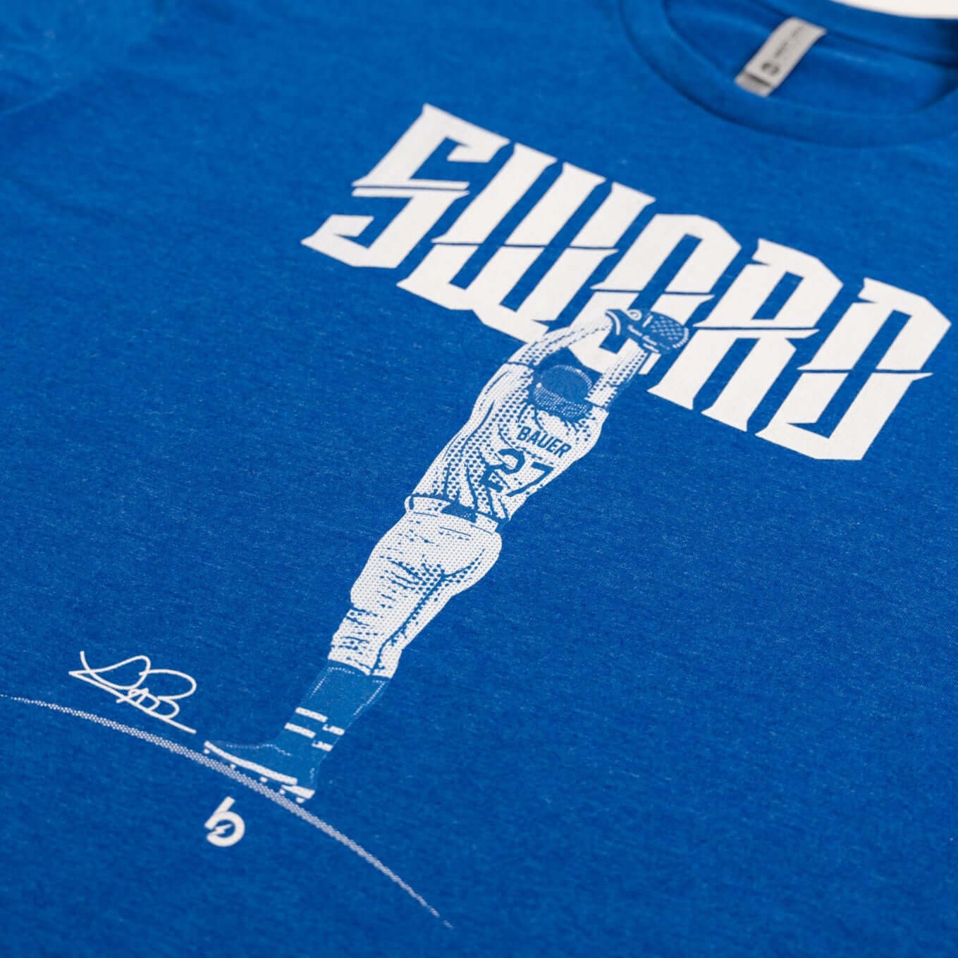 Bauer Outage Sword Tee featuring bold "SWORD" design and graphic of player, representing strength and resilience.