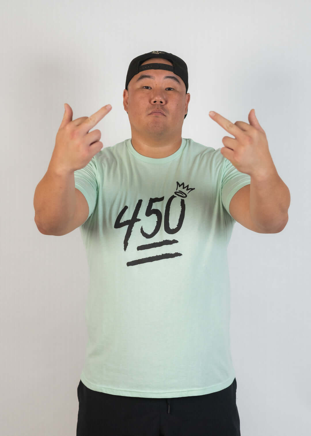 Model showcasing the King of Juco 450 Crown Tee in mint green, emphasizing power with "450" and crown design.