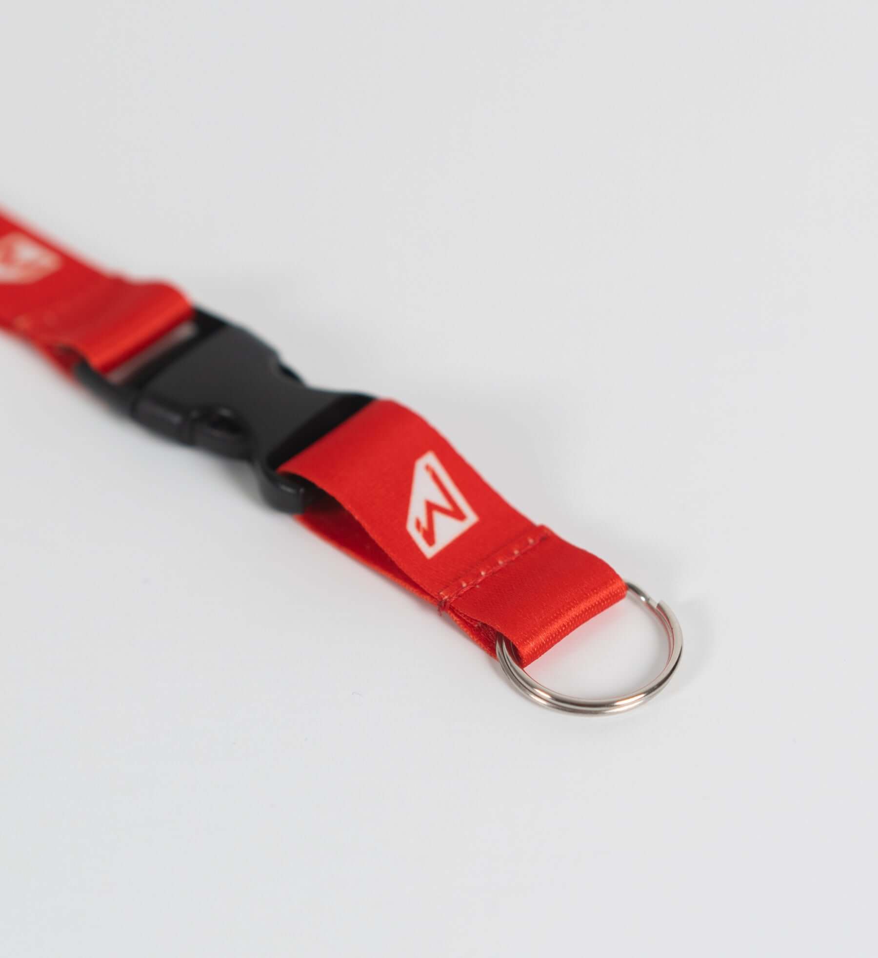 Close-up of the red Momentum Lanyard featuring a breakaway buckle and keyring for secure access and style.