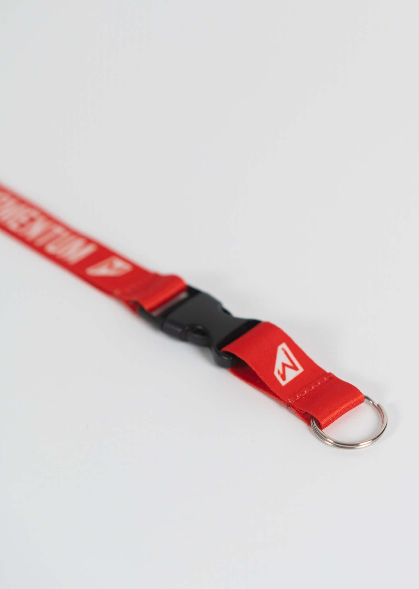 Red Momentum Lanyard featuring breakaway buckle and keyring for style and practicality in everyday use.