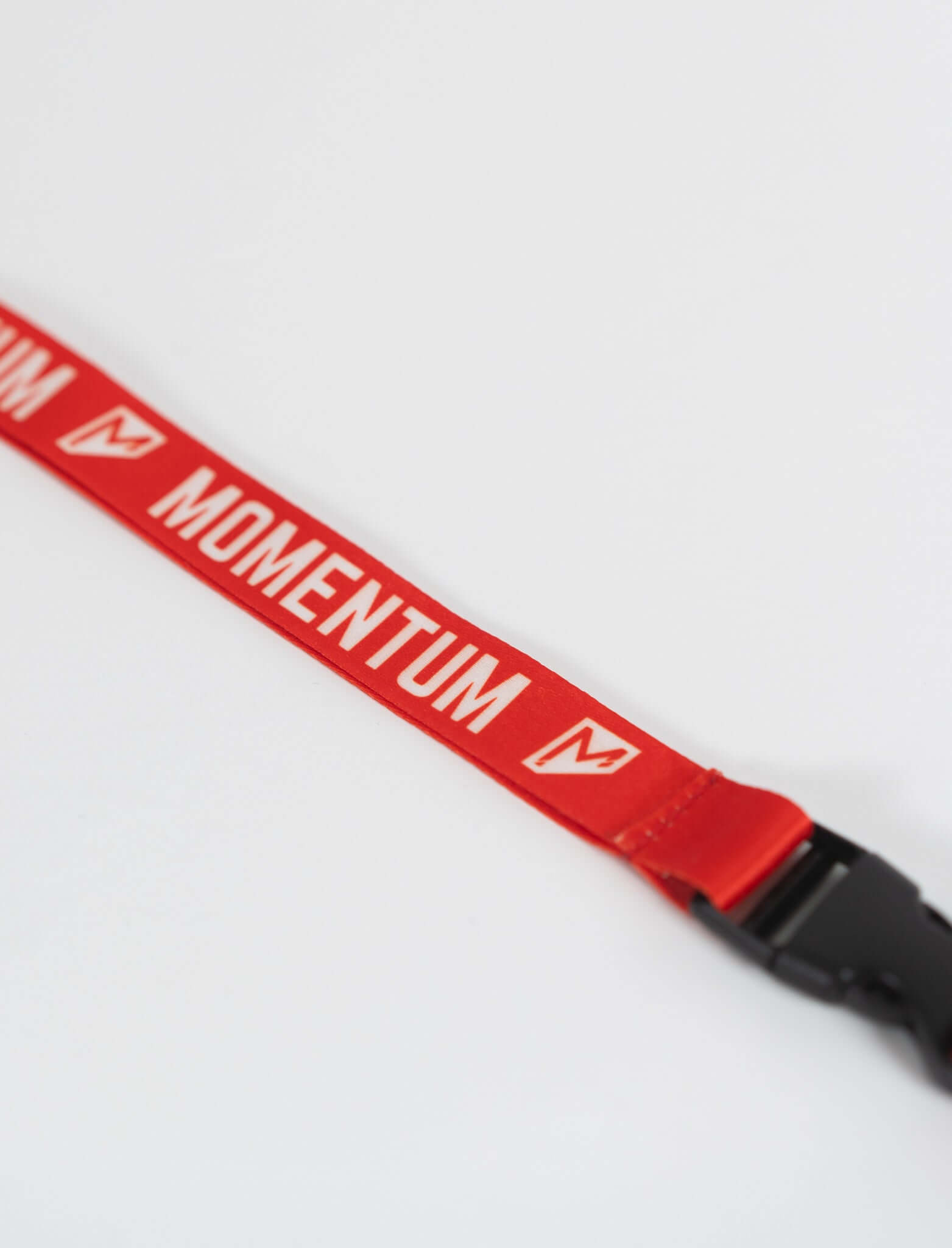 Red Momentum lanyard featuring a breakaway buckle and keyring, made from durable dye-sublimated polyester.