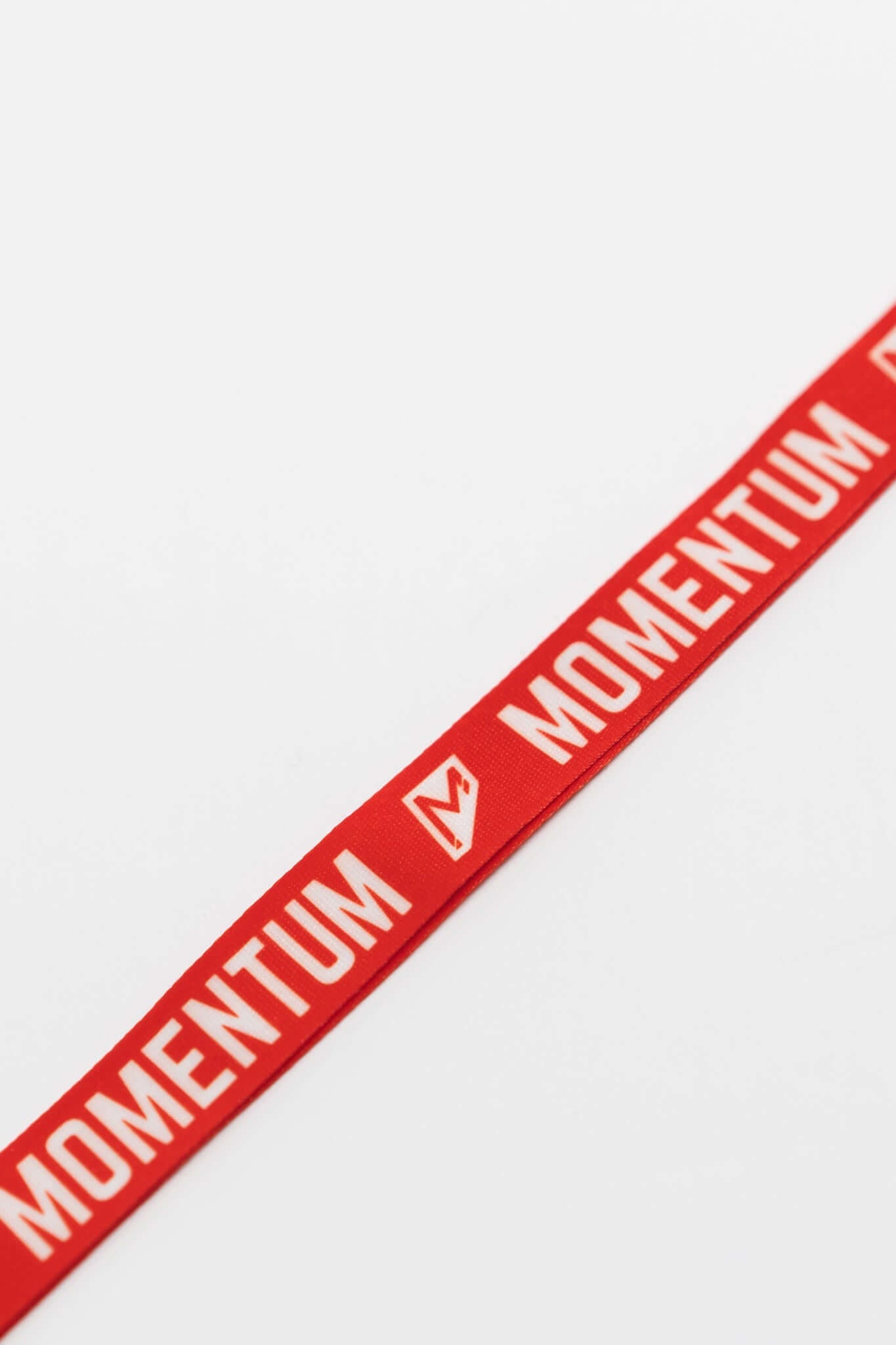 Red Momentum Lanyard featuring bold white lettering, perfect for style and security with a breakaway buckle and keyring.