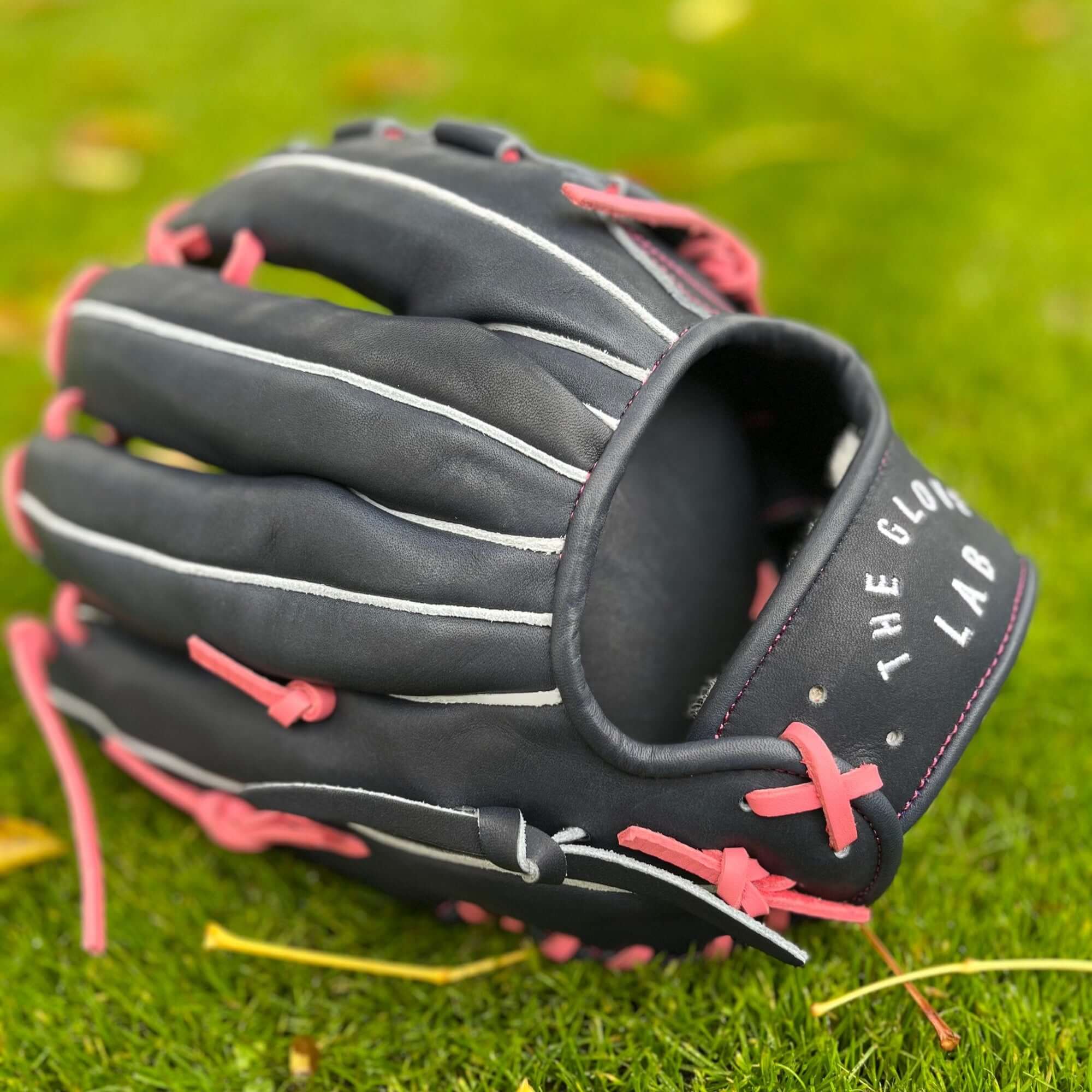 Detailed look at finger area showing durable navy and pink construction.