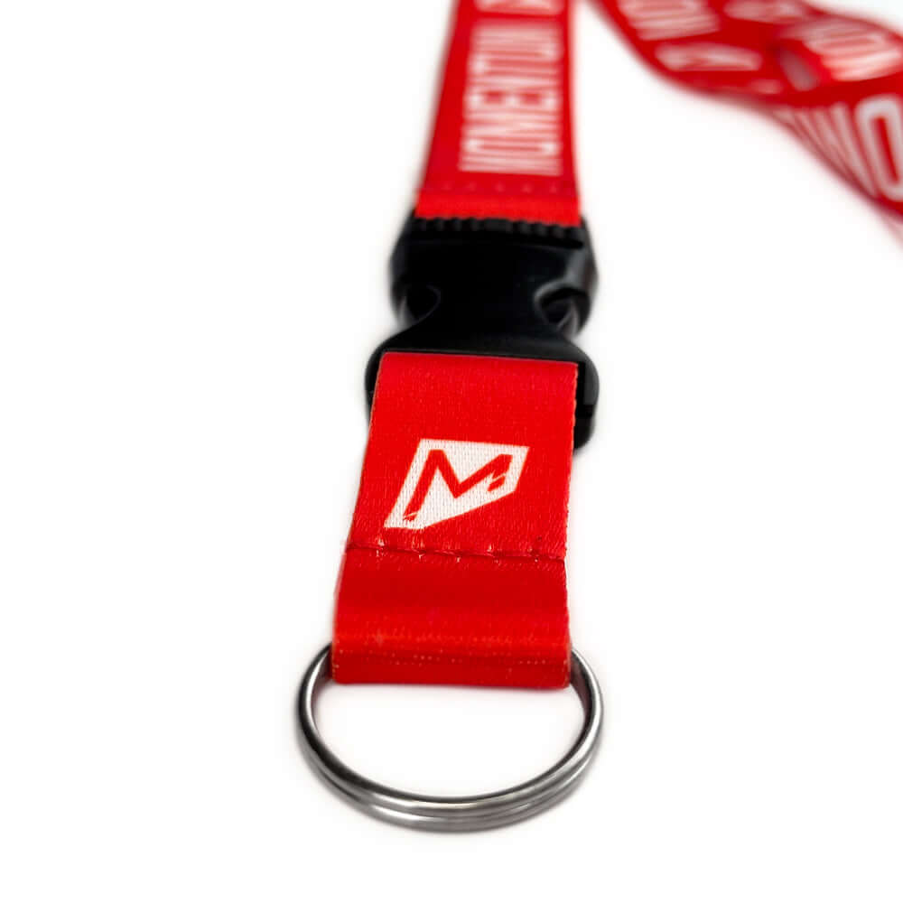 Close-up of a red Momentum Lanyard featuring a breakaway buckle and keyring for secure access to essentials.