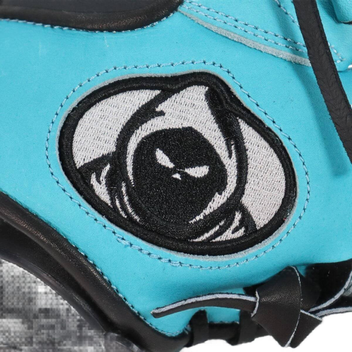 Shadow Shiver 12" RHT glove close-up featuring a bold black and white logo on aqua blue leather.