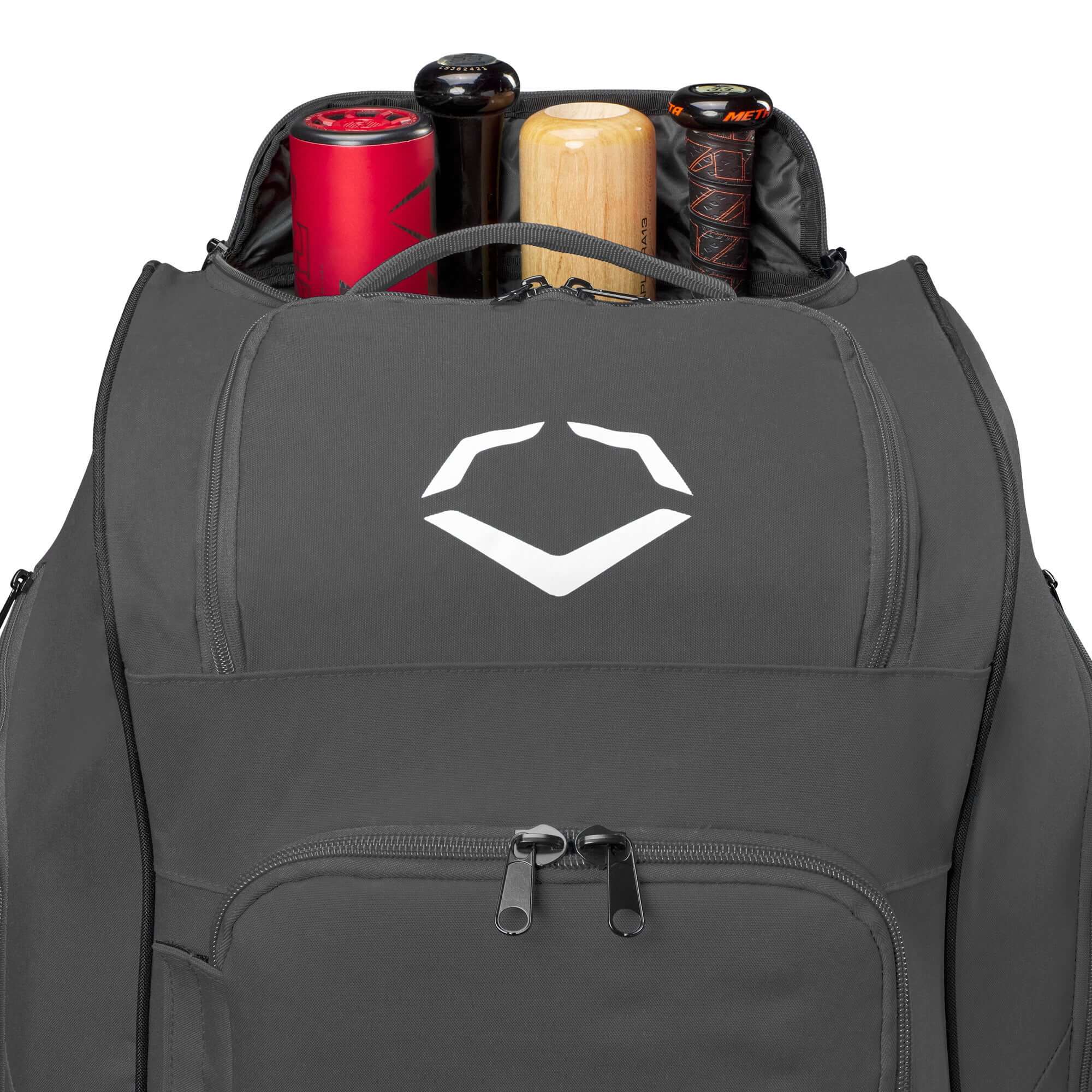 Evoshield Stonewall 2.0 Wheeled Bag with bats stored in the top compartment, showcasing its spacious design for sports equipment.