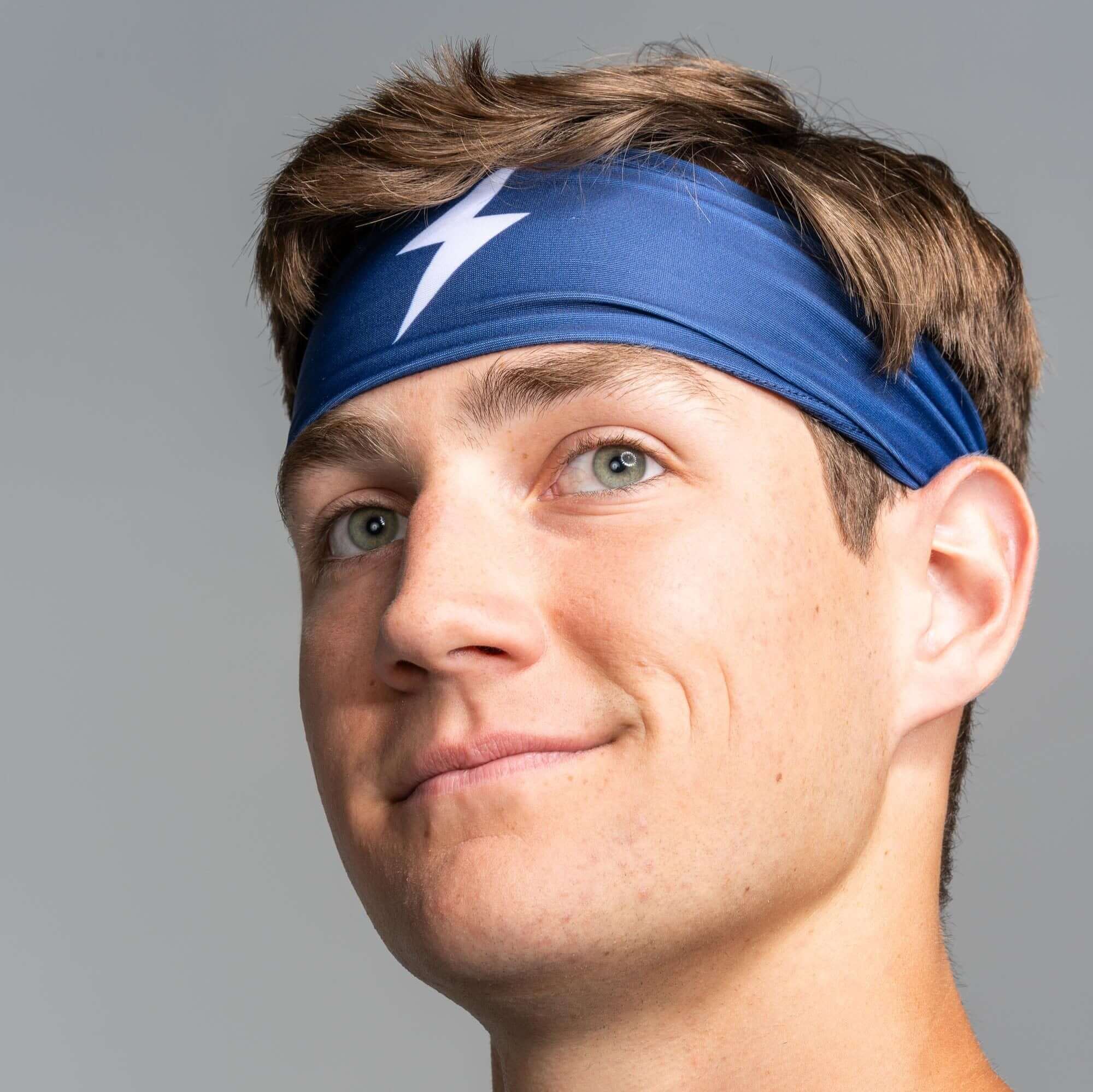 Bruce Bolt Performance Headband worn by a young man, showcasing its lightweight design and moisture-wicking fabric.