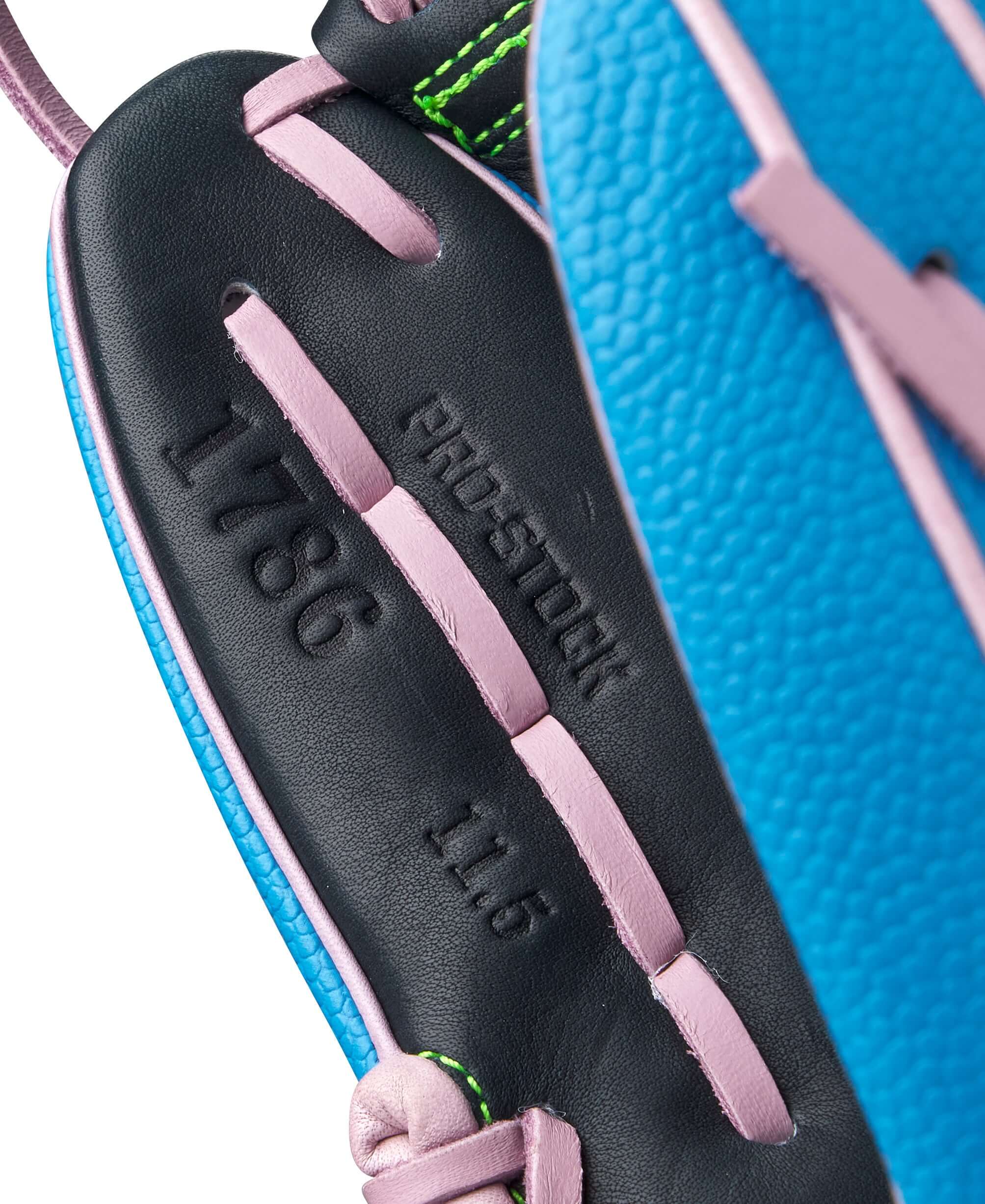 Close-up of Wilson A2000 1786SS glove, featuring Sky Blue SuperSkin and Pro Stock leather details.