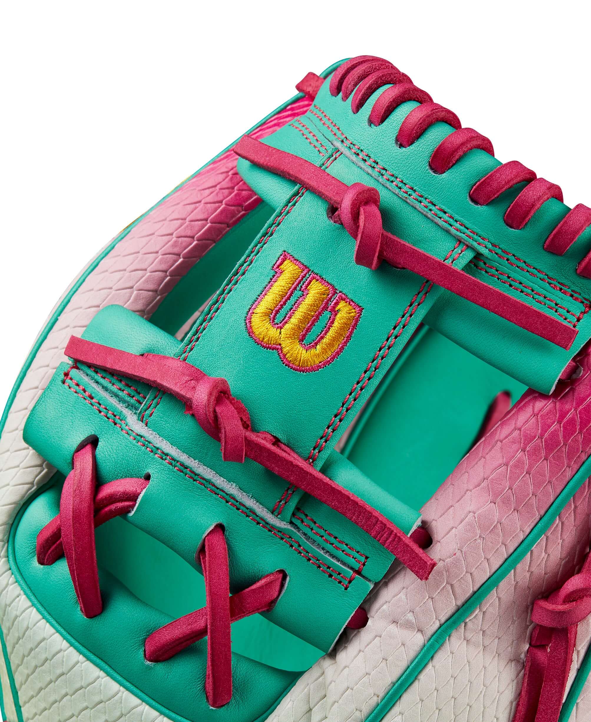 Close-up of Wilson A2000 1975 glove showcasing Pink to Seafoam gradient and bold logo details.