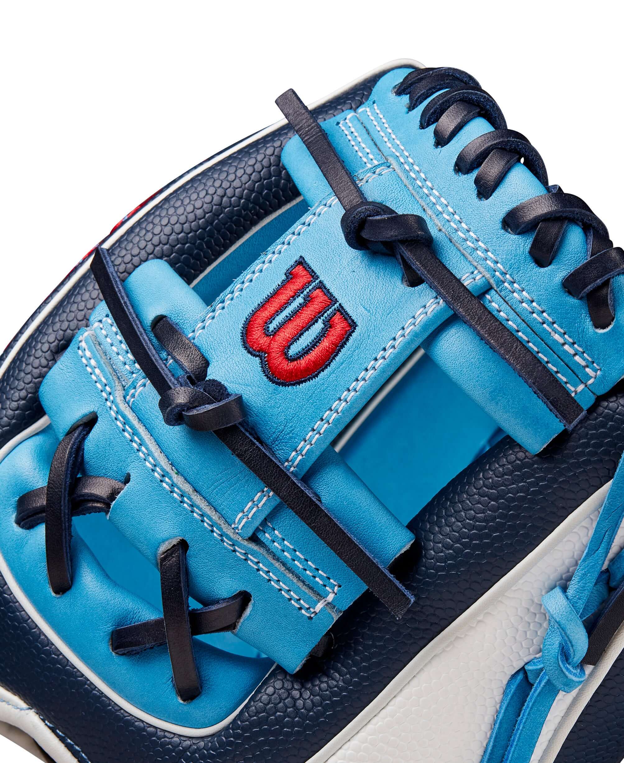 Close-up of Wilson A2000 PF88SS baseball glove with navy, sky blue leather, and red logo detail.