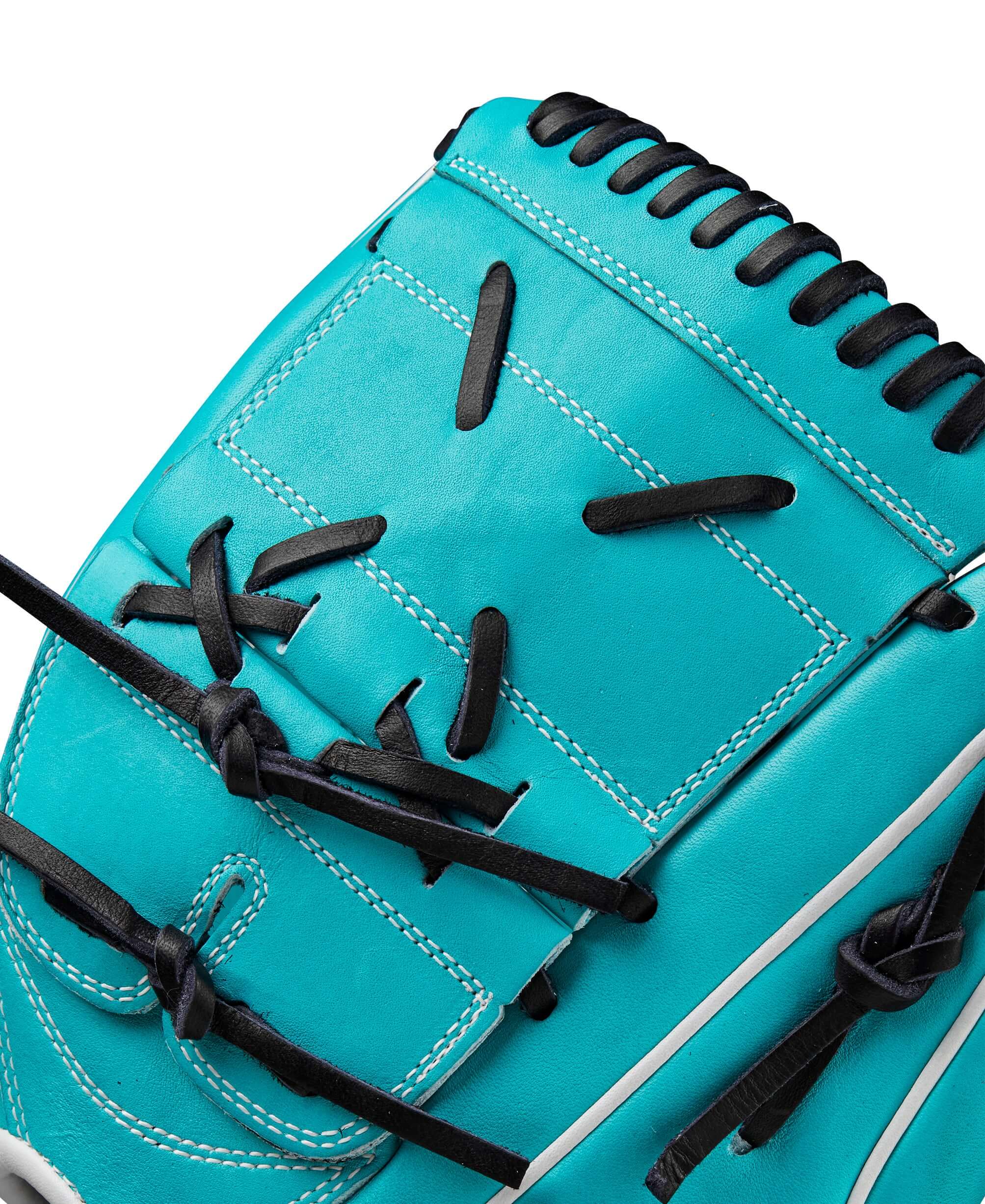 Close-up of the Wilson A2000 SA17 teal and white baseball glove, showcasing the intricate lacing and stitching details.