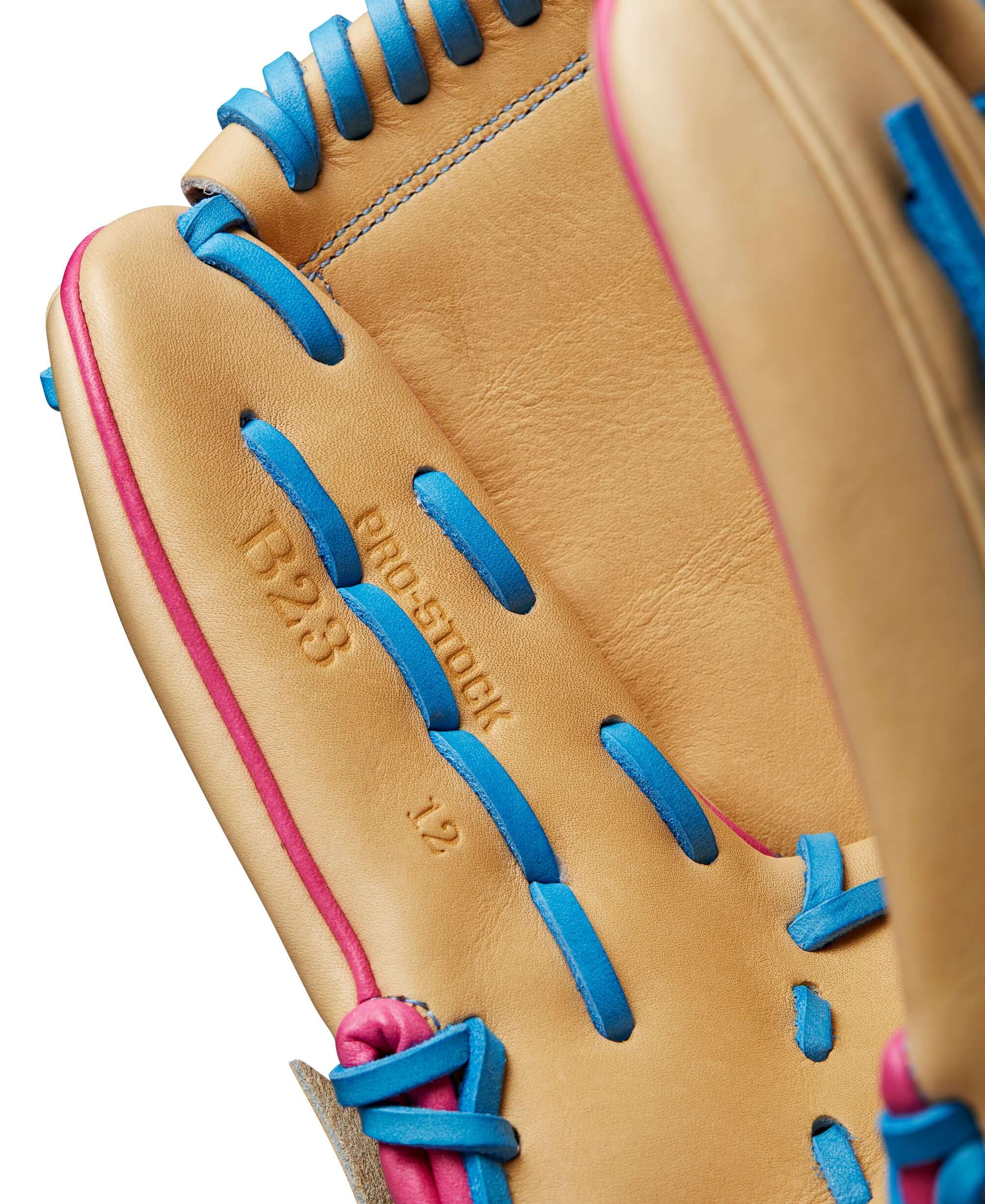 Close-up of Wilson A2000 B23 glove highlighting Blonde Pro Stock leather with Sky Blue and Pink stitching accents.