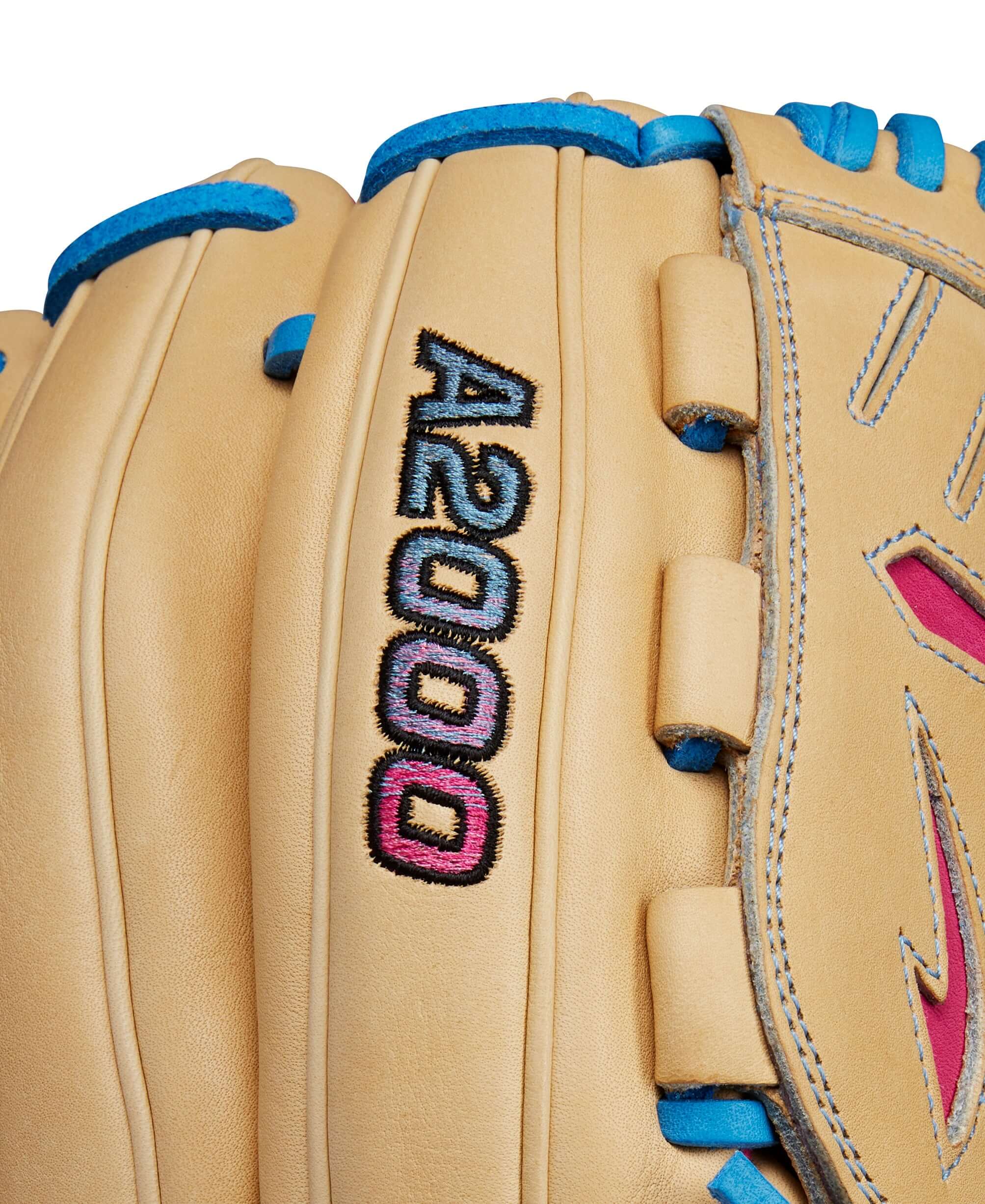 Close-up of Wilson A2000 B23 glove showcasing blonde leather with blue and pink accents.