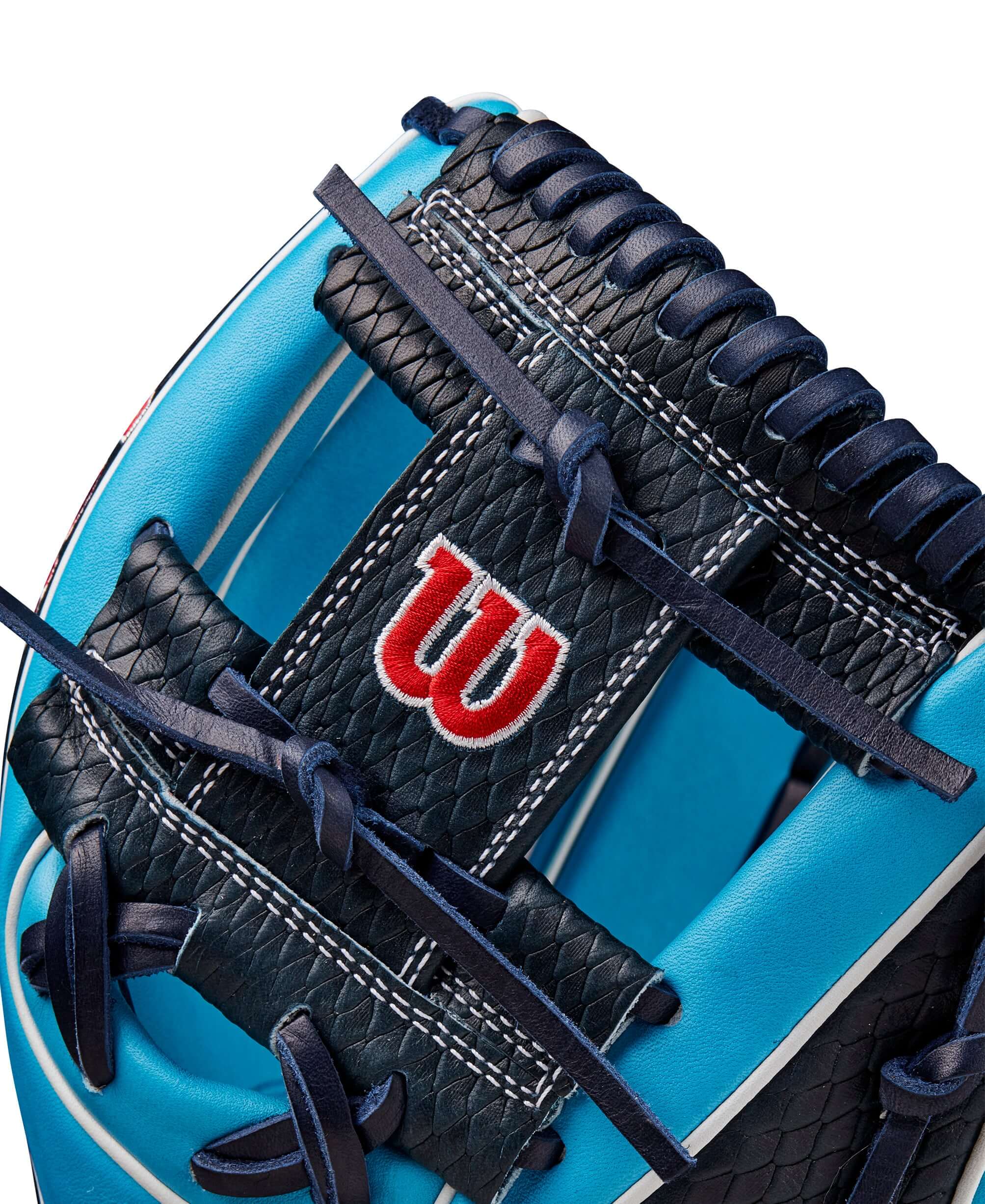 Close-up of the Wilson Winter 2024 A2K 1786 glove showing Tropical Blue leather and navy lacing details.