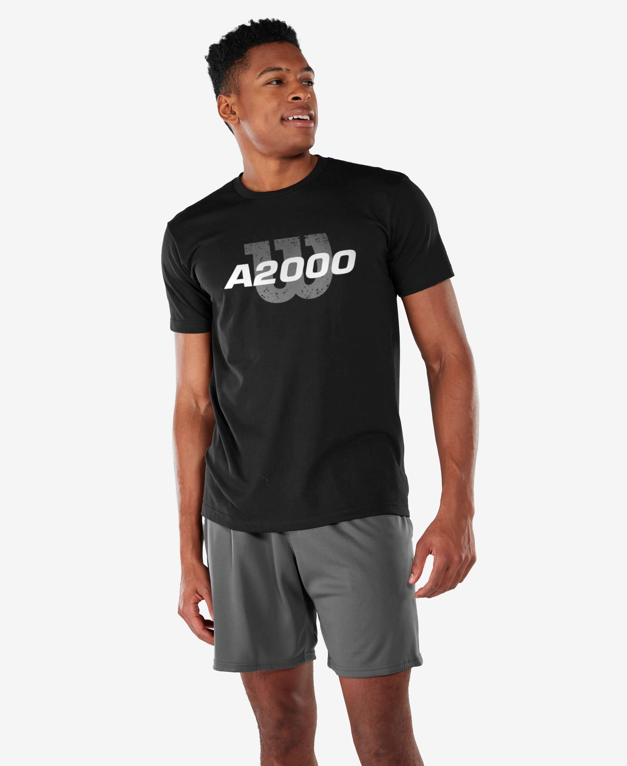 Wilson Adult Distressed Tee in black featuring A2000 graphic, paired with athletic shorts, showcasing a sporty look.